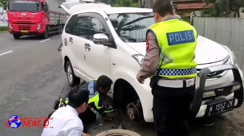 Cepat Dekat dan Bersahabat Polisi Bantu Pengendara Yang Kesulitan Saat Ban Mobilnya Bocor di Jalan Raya Lumajang